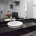Motel 6 Columbus Oh - Osu North bathroom vanity with round sink, black countertop, mirror and towels