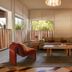 Royal Sun Palm Springs lobby lounge with red chairs, sofa, coffee table, and wood double doors