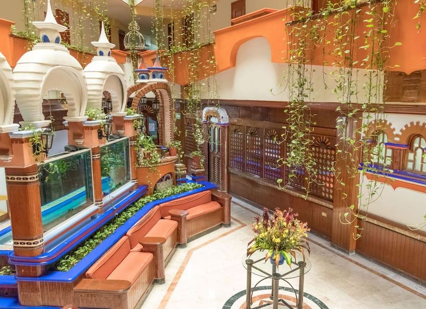 Hotel Báez Carrizal in Villahermosa courtyard with hanging vines, benches, and decorative arches