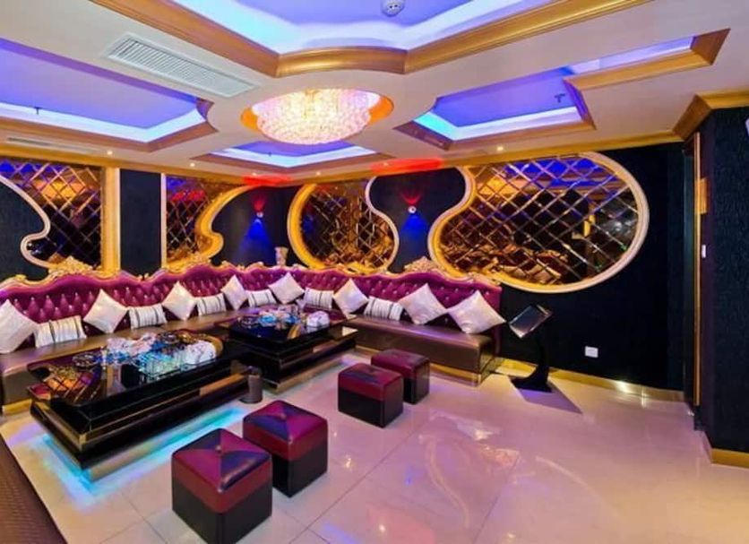 Yunhai Hotel Zhuhai lounge with curved sectional seating, ornate wall décor and colorful ceiling lights