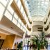 Alcala Plaza lobby in Alcalá de Henares with glass atrium skylight and indoor palm plants