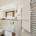 Tailormade Hotel Rüden Schaffhausen bathroom with wall-mounted toilet, sink, towel warmer and mirror