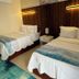 Le Bleu Bed and Breakfast in Providenciales: guest room with two beds, wood headboard and teal rug