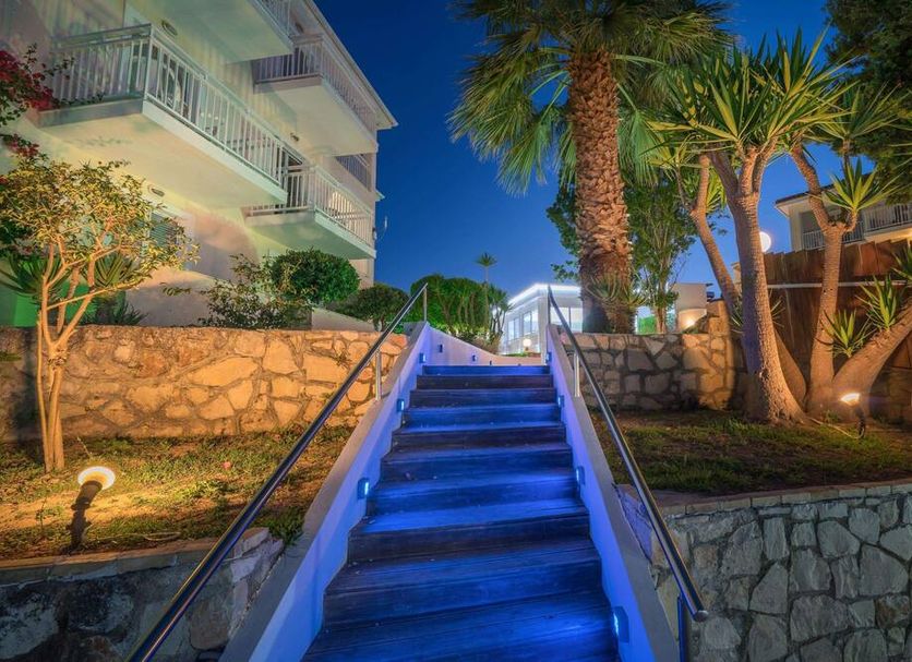 Diana Palace Hotel Zakynthos in Argassi, lit blue stairway with palm trees and stone landscaping