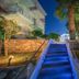 Diana Palace Hotel Zakynthos in Argassi, lit blue stairway with palm trees and stone landscaping