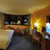 Hôtel Mercure Alger Aéroport guest room with king bed, desk, and city view in Algiers