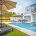 Casa Toñita in Levittown: outdoor pool with lounge chairs, umbrellas and a modern white courtyard