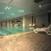 Indoor pool at Xiang Ming Holiday Hotel in Huangshan with lounge chairs and tiled deck