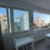Maria's Place - Adults Only in Oia dining area with large windows and views of white buildings