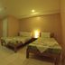 Lylie Hotel Mandaue City room with two single beds, tiled floor, desk, window, and warm lighting