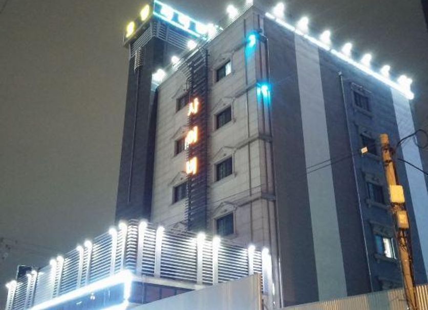 Cyber Motel in Gunsan, exterior at night with illuminated building facade and rooftop lights