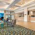 Holiday Inn Orlando-Disney Springs Area lobby with seating area, Disney-themed backdrop and front desk in Lake Buena Vista