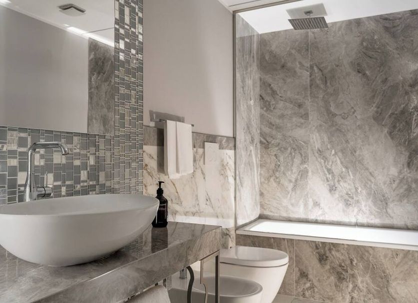 Hotel Campo Marzio in Vicenza bathroom with stone vanity, vessel sink, mosaic tile, and walk-in shower