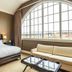 The Inn At Cobble Beach room with king bed, sofa and large arched window overlooking Balmy Beach.