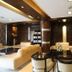 Hotel Waves, Delhi Airport lobby lounge in New Delhi with beige sofas, glass tables and warm lighting