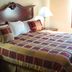 Western Motel Inn and Suites Hazlehurst guest room with king bed, lamps, and window light