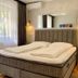 Hotel Maj Inn in Moravske Toplice guest room with double bed, wall mirror, and window with curtains