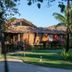 Pousada Estrela D' Agua in Trancoso, rustic bungalow amid tropical gardens and palm trees