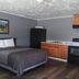 Essex Motel Alturas room with bed, kitchenette, and wood-look flooring