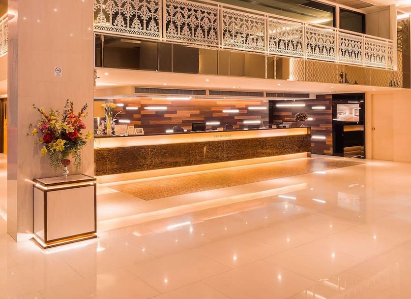 Grand Lord Boutique Hotel -Srinakarin in Bangkok lobby with a front desk and glossy marble floor