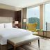 Courtyard by Marriott Seoul Myeongdong guest room with king bed, city view, and yellow chair