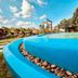Amphawa Club Resort & Spa in Amphawa with a curved blue pool and tropical garden views
