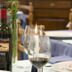 Hotel & Residence Parador in Cesenatico dining table with wine bottle, glasses, and floral centerpiece