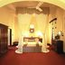 Bandarawela Hotel bedroom with four-poster bed, red carpet, arched ceiling and mirror in Bandarawela
