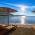 Sunrise Hotel in Pefki beach with sun loungers, straw umbrellas and calm sea view