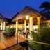 Grand Palladium Kantenah Resort & Spa in Akumal, lit thatched dining pavilion with wooden walkway