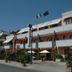 Hotel Mistral in Campo nell'Elba with balconies, flags, and a street-side entrance under a blue sky