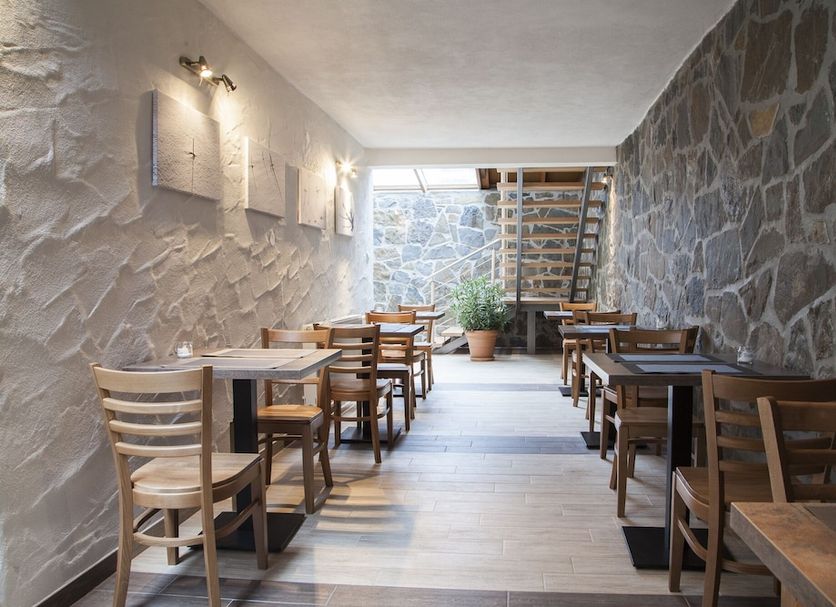 Penzion Snezienka in Tatranska Lomnica stone-walled restaurant seating with wooden tables and chairs