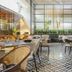 Yogi Executive, Navi Mumbai restaurant with woven chairs, patterned floor, and bright modern dining area