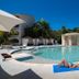 Presidential Suites by Lifestyle, Puerto Plata: outdoor pool with guests lounging on a deckchair