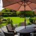The Bedford Hotel in Tavistock garden patio with umbrella, table and wicker chairs