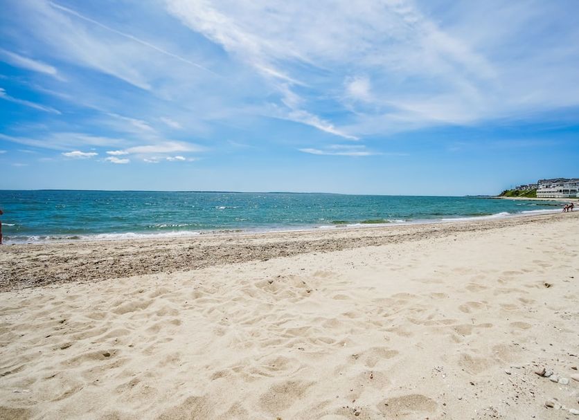 Sandy beach and turquoise ocean at InnSeason Resorts Captain's Quarters in Falmouth