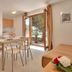 Maistra Apartments Villas Rubin, Rovinj apartment with dining area and open patio doors to garden view