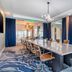 Cambria Hotel Waco University Riverfront meeting room with long conference table and blue curtains in Waco