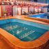 Rhogem Hotel in Takoradi: outdoor pool area with lounge chairs and string lights