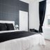 Rosebank Guest House in Perth: elegant double room with black-and-white bedding, bedside lamps, and large window.