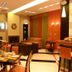 Alexandros Boutique Hotel in Náfplio dining area with tables, chairs, and warm lounge seating