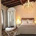 The Stay Galata in Istanbul features an elegant bedroom with chandelier, canopy shower, and desk