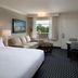 Sanibel Island Beach Resort guest room with king bed, sofa, desk and balcony view in Sanibel