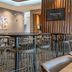 SpringHill Suites by Marriott Woodbridge lobby lounge with high-top tables, bar stools and dining area