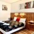 Central Motel Mildura room with double bed, wood-paneled headboard and mirrored wardrobe in Mildura