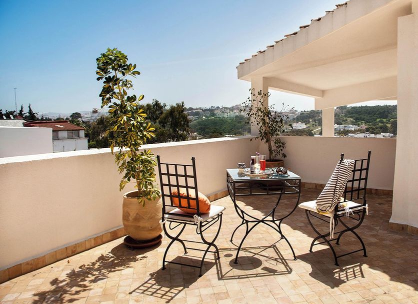 Dar Tanja in Tangier terrace with table, chairs, potted plant and city views
