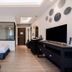 Sabai Mansion Pool & Spa in Krabi guest room with two beds, TV, wood flooring and wall decor