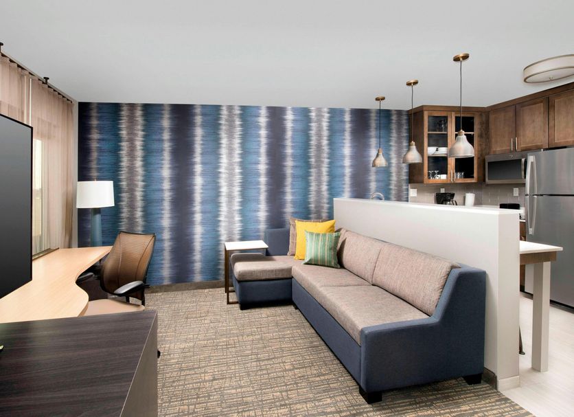 Residence Inn by Marriott New Orleans Elmwood suite with sofa, desk, and kitchen area