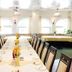 Hotel & Restaurant Park Cafe Isa in Erfurt dining room with long set tables and arched windows
