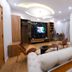 Arabella Residence in Cairo living room with TV wall, seating area, and wood flooring